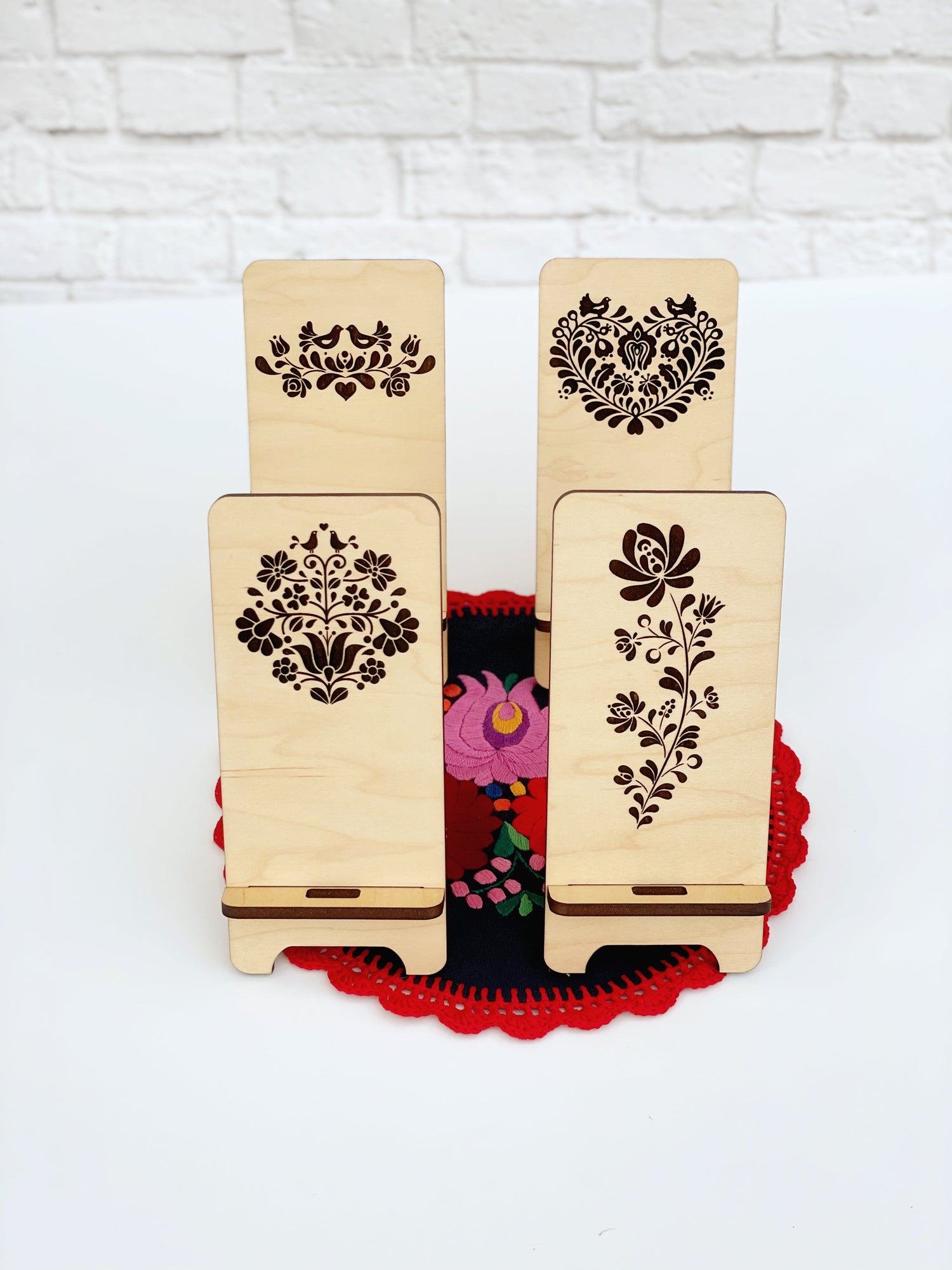Laser-engraved custom phone stands and key fobs with Hungarian folk motifs