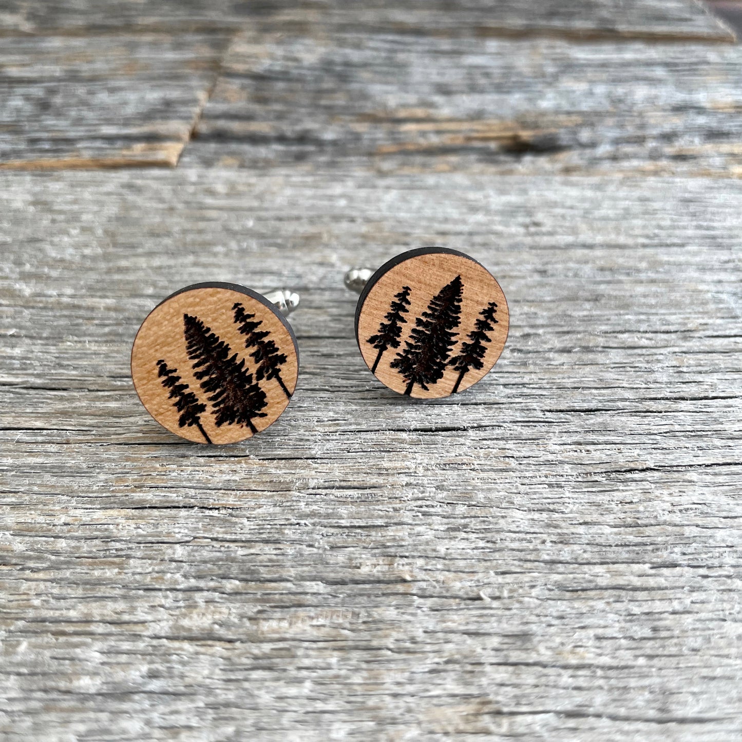 Engraved wood cufflinks with tall pine trees,