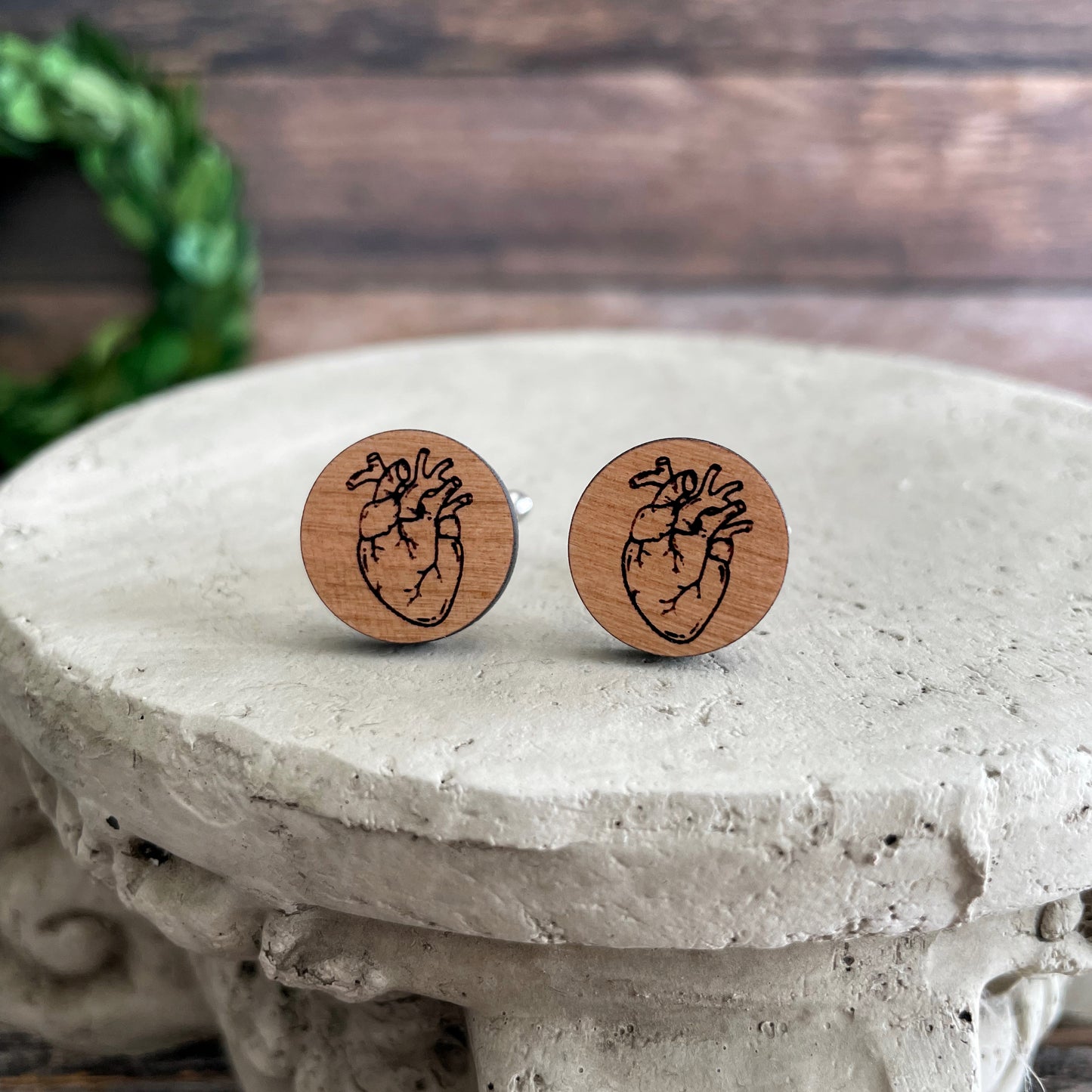 Laser engraved wooden cufflinks with a drawing of a heart